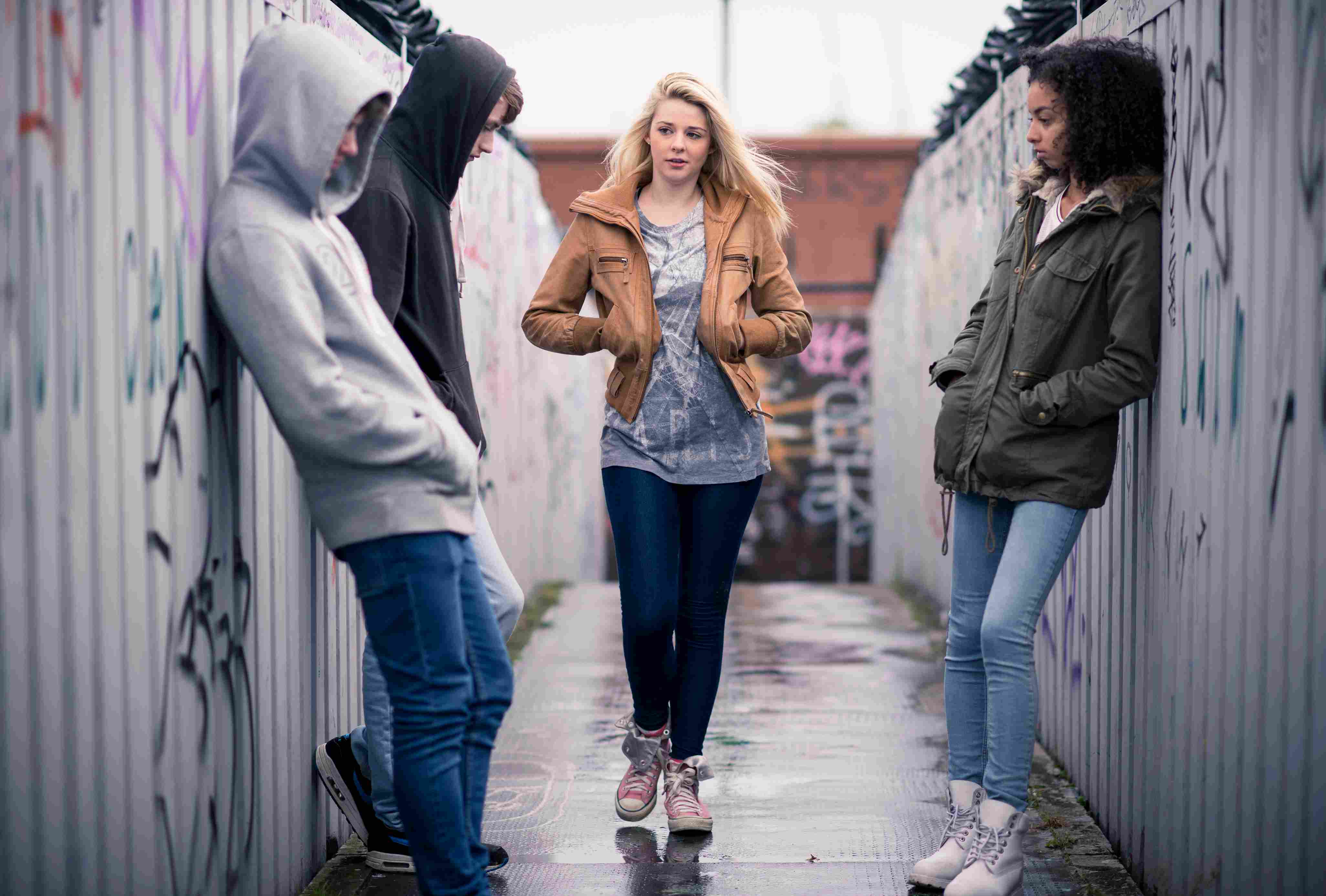 A group of people disturbing a woman